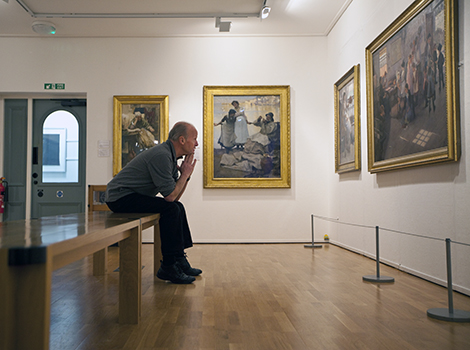 UK - Cornwall - Author Jim Crace in the room dedicated to paintings by the Newlyn School at the Penlee House Gallery